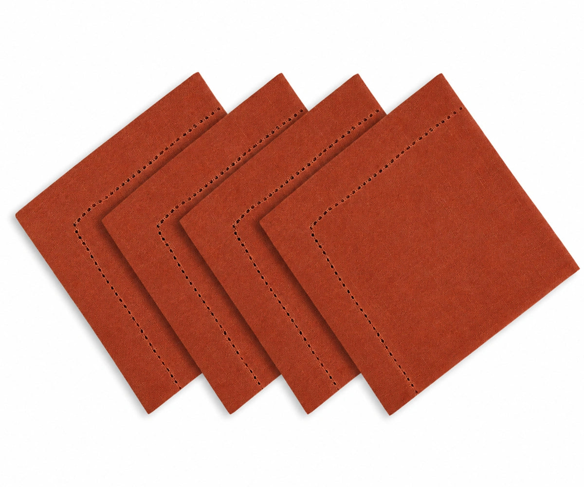 Four rust-colored felt square coasters with decorative dashed stitching, arranged in a staggered stack on a white background.