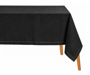 Black cotton linen rectangular tablecloth with a hemstitched border draped over a dining table.