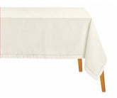 Rectangular ivory hemstitched tablecloth draped over a dining table