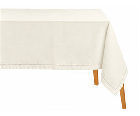 Rectangular ivory hemstitched tablecloth draped over a dining table