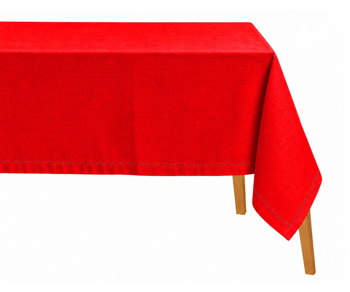 Red cotton linen rectangular tablecloth with hemstitched border draped over a dining table.
