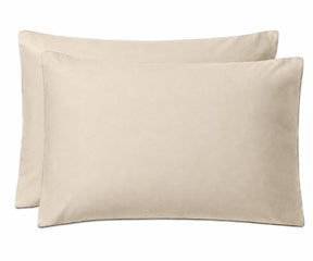 Two plain rectangular pillowcases in a light warm beige color, shown overlapping on a clean white background.
