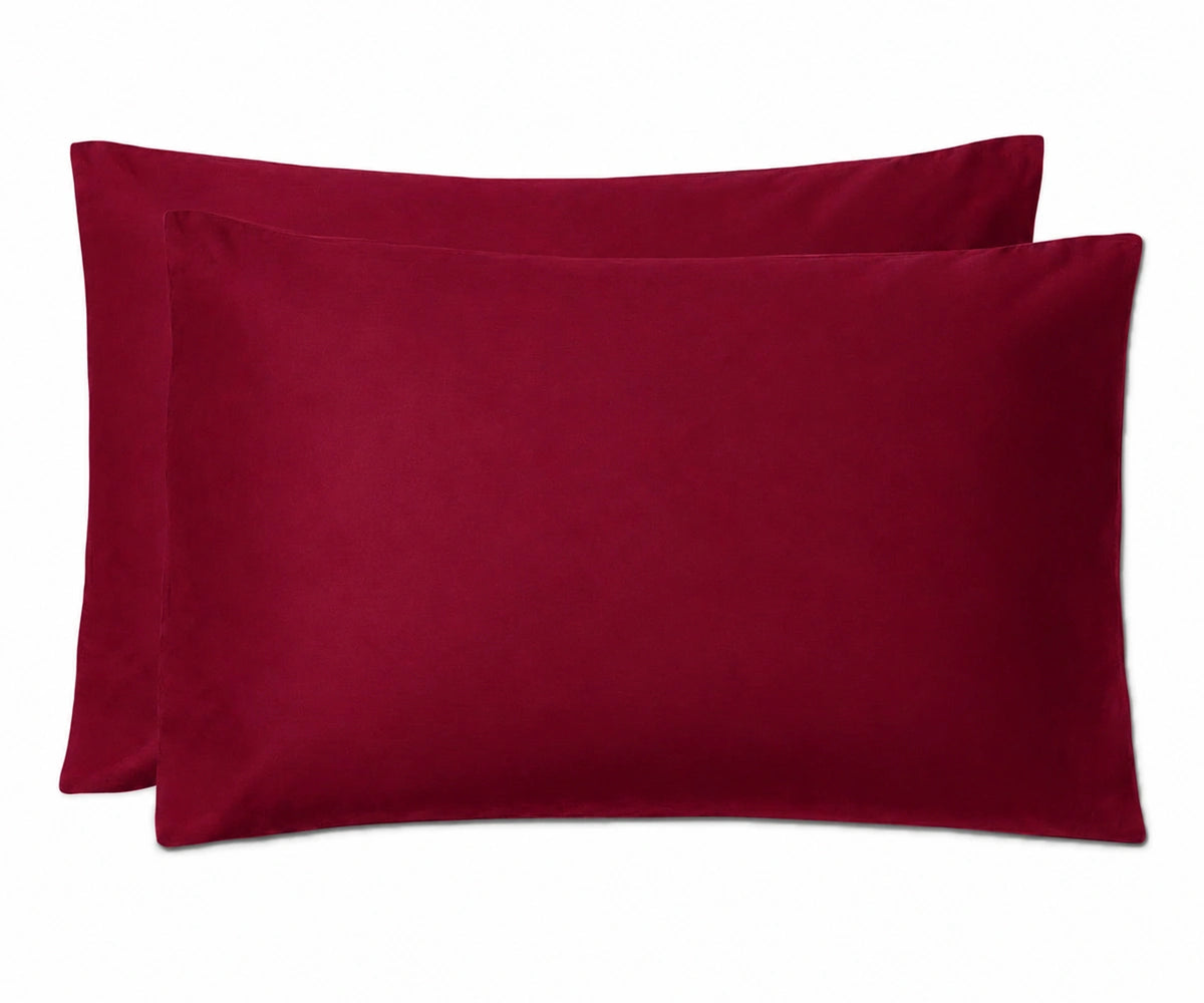 Two deep burgundy pillowcases stacked together on a plain white background.