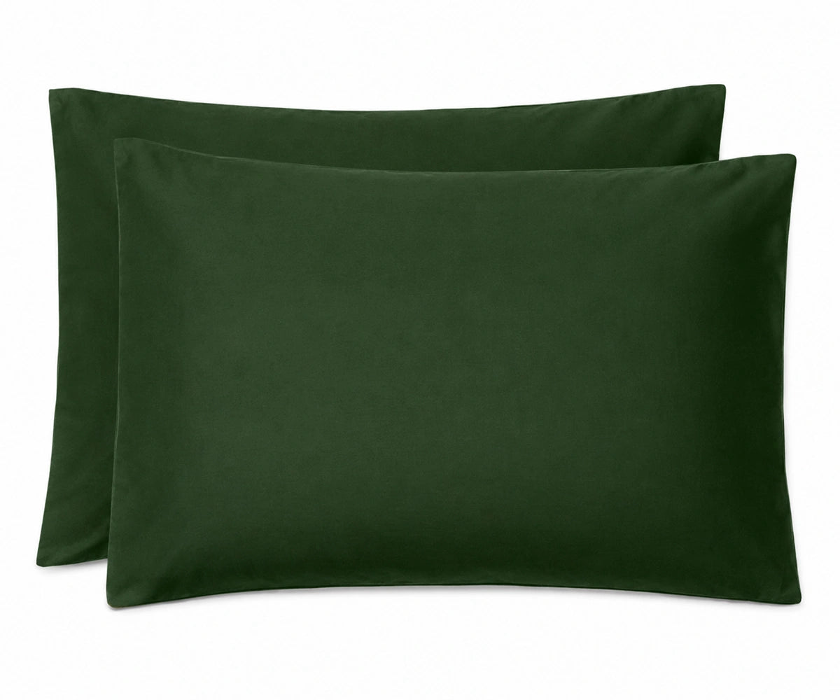 Two dark forest green pillowcases stacked together on a plain white background.