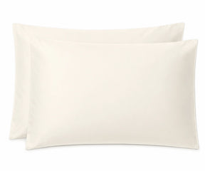 Two plain ivory pillowcases stacked slightly offset against a clean white background.