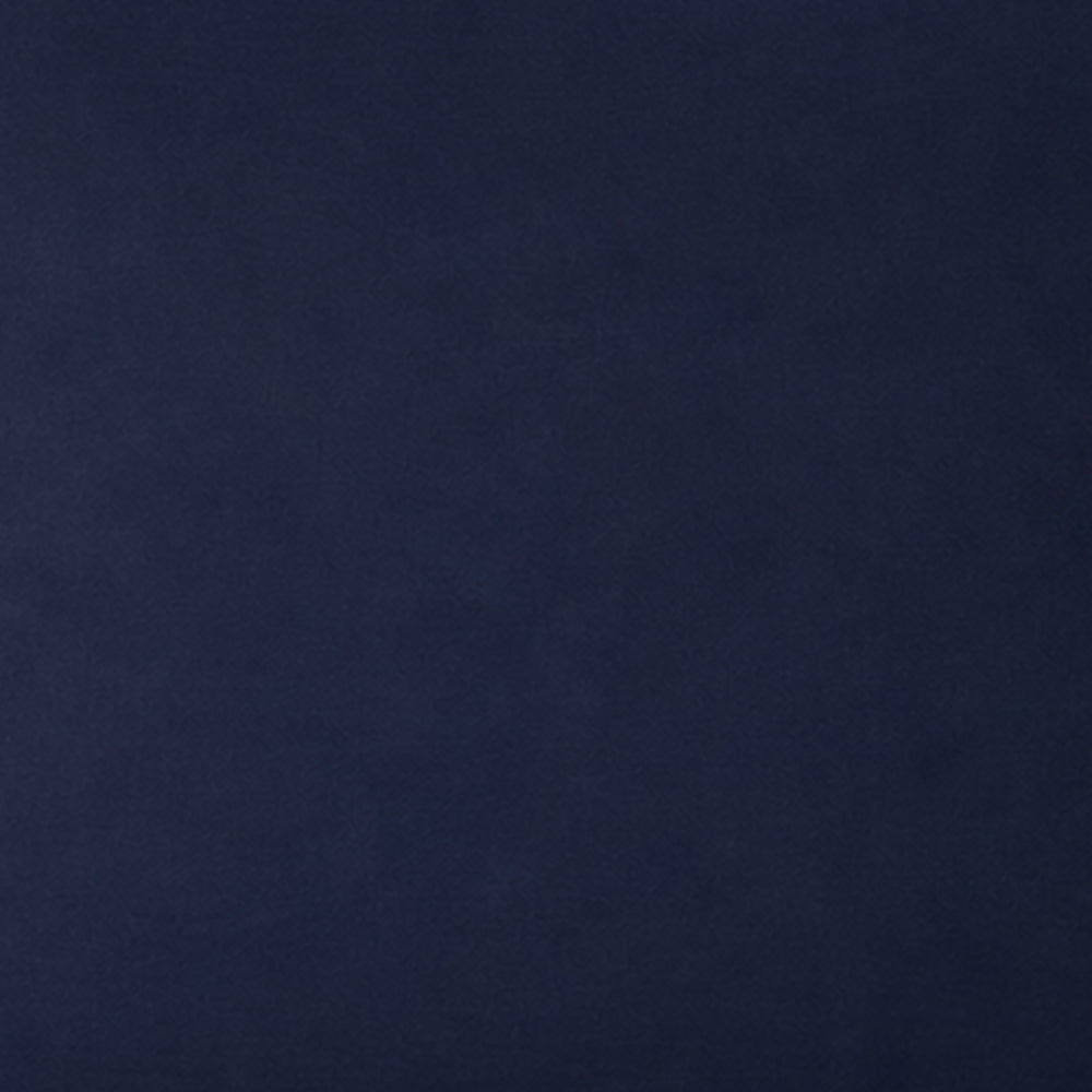 A close-up of a solid dark navy blue textured surface, likely fabric or leather.