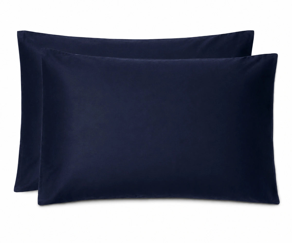 Two navy blue pillowcases stacked together on a plain white background.
