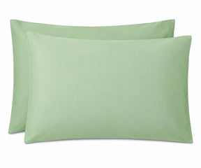 Two light sage green pillowcases shown on a plain white background.
