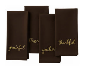 Brown holiday napkin featuring gold stitched words – Grateful, Blessed, Gather, Thankful.