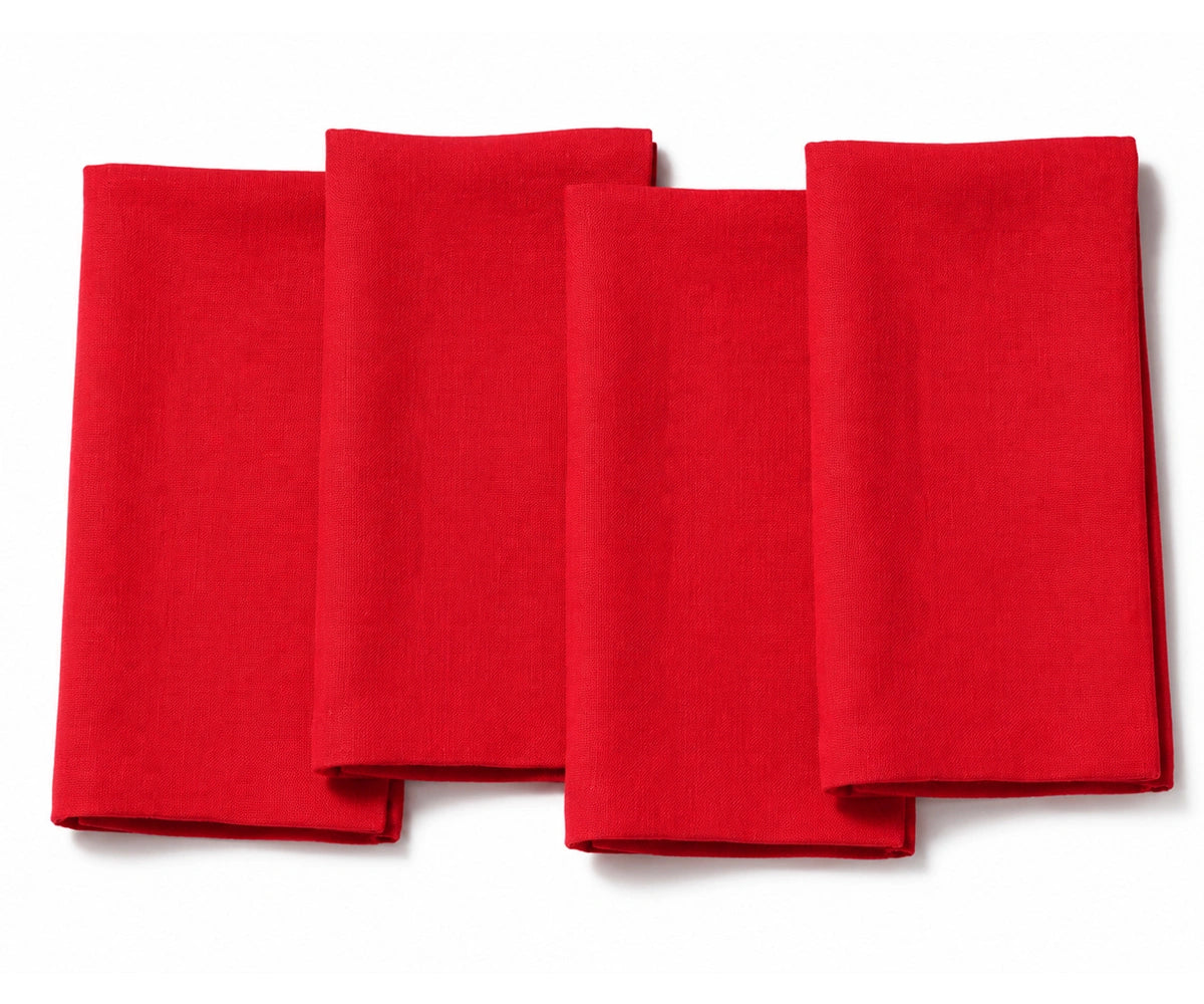 Set of four folded red dinner napkins arranged on a white background.
