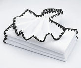 White napkins with black  triangle embroidered edge – premium cotton dinner napkins for weddings and parties.