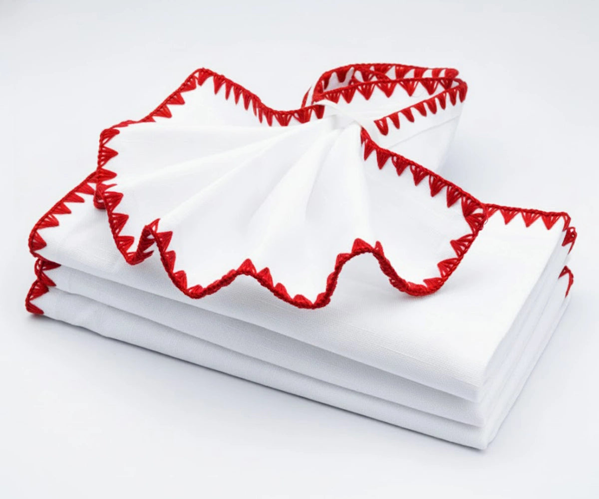 White napkins with red embroidered edges – festive cotton dinner napkins for holiday table décor.