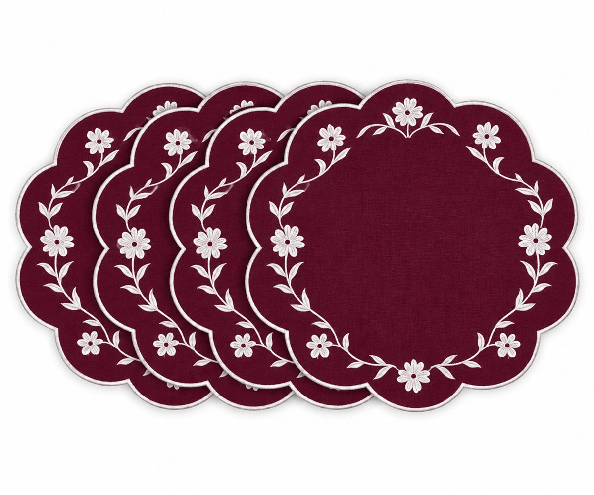 Burgundy scalloped placemats with white floral embroidered border design