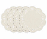 Four round placemats with scalloped edges, featuring a white floral vine border on a warm cream linen background, arranged in a fan shape on a white background.