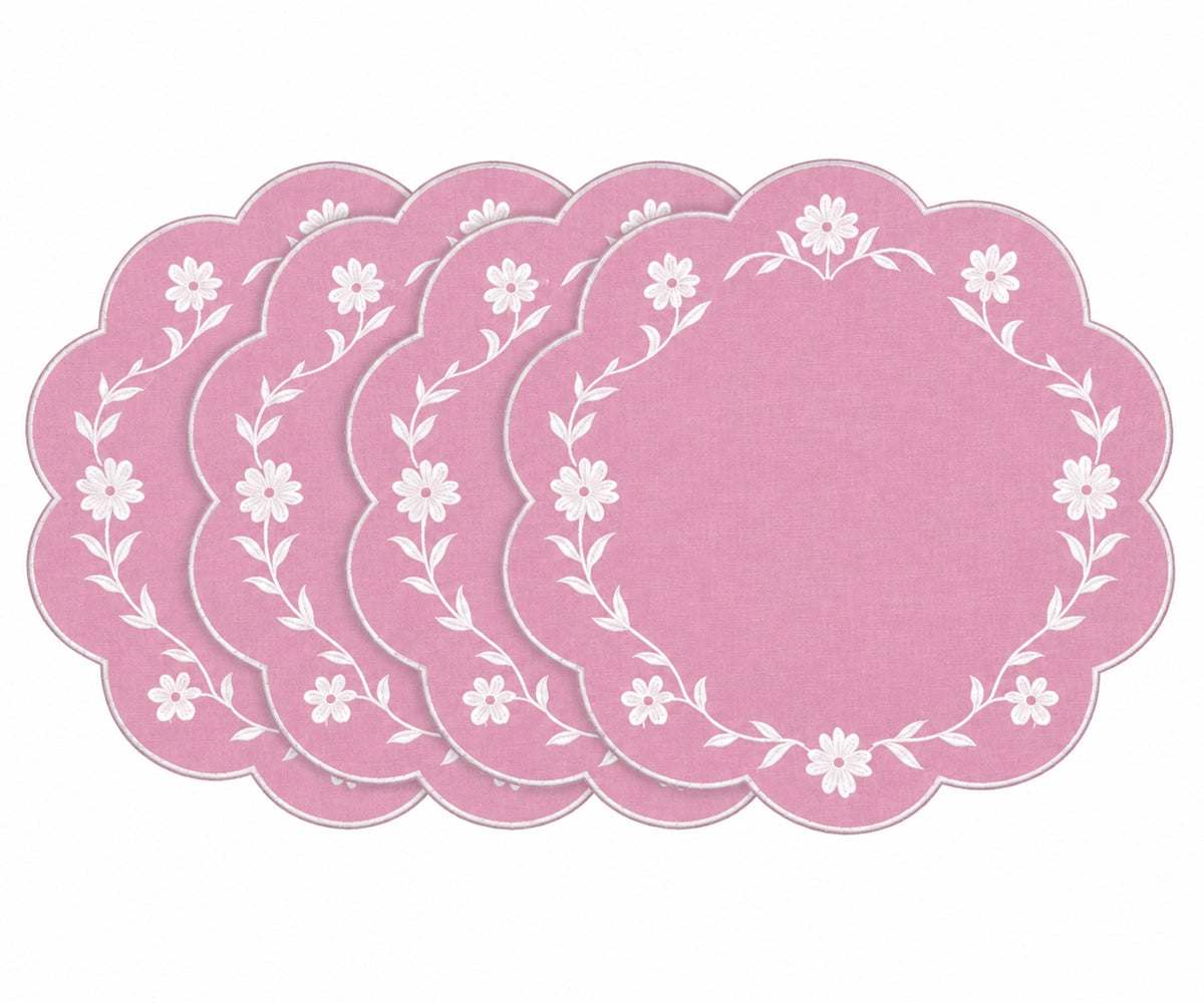 pink scalloped placemats with white floral embroidered border design