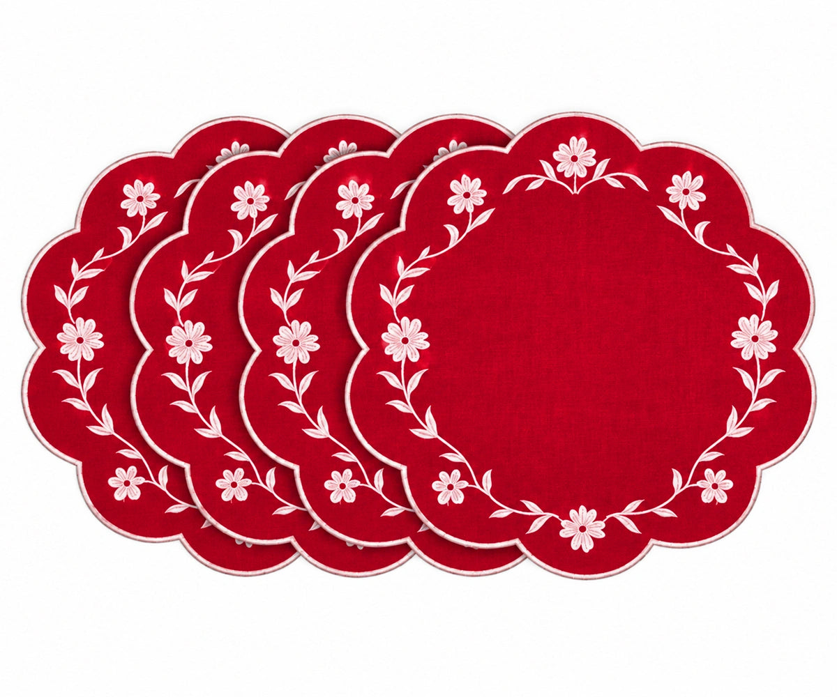 Red scalloped placemats with white floral embroidered border design