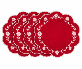 Red scalloped placemats with white floral embroidered border design