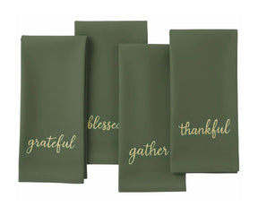 Light green sentiment embroidered napkin with gold stitching for winter and Christmas décor.