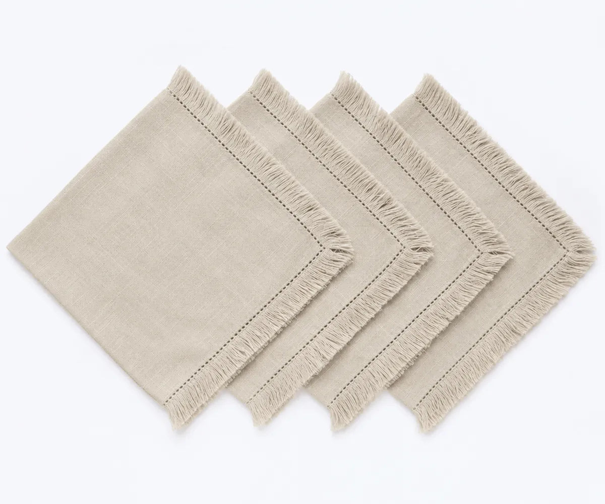 Shop natural cotton napkins with woven fabric and fringe trim. Ideal for farmhouse dining, holiday tables, dinner parties, and elegant place settings.