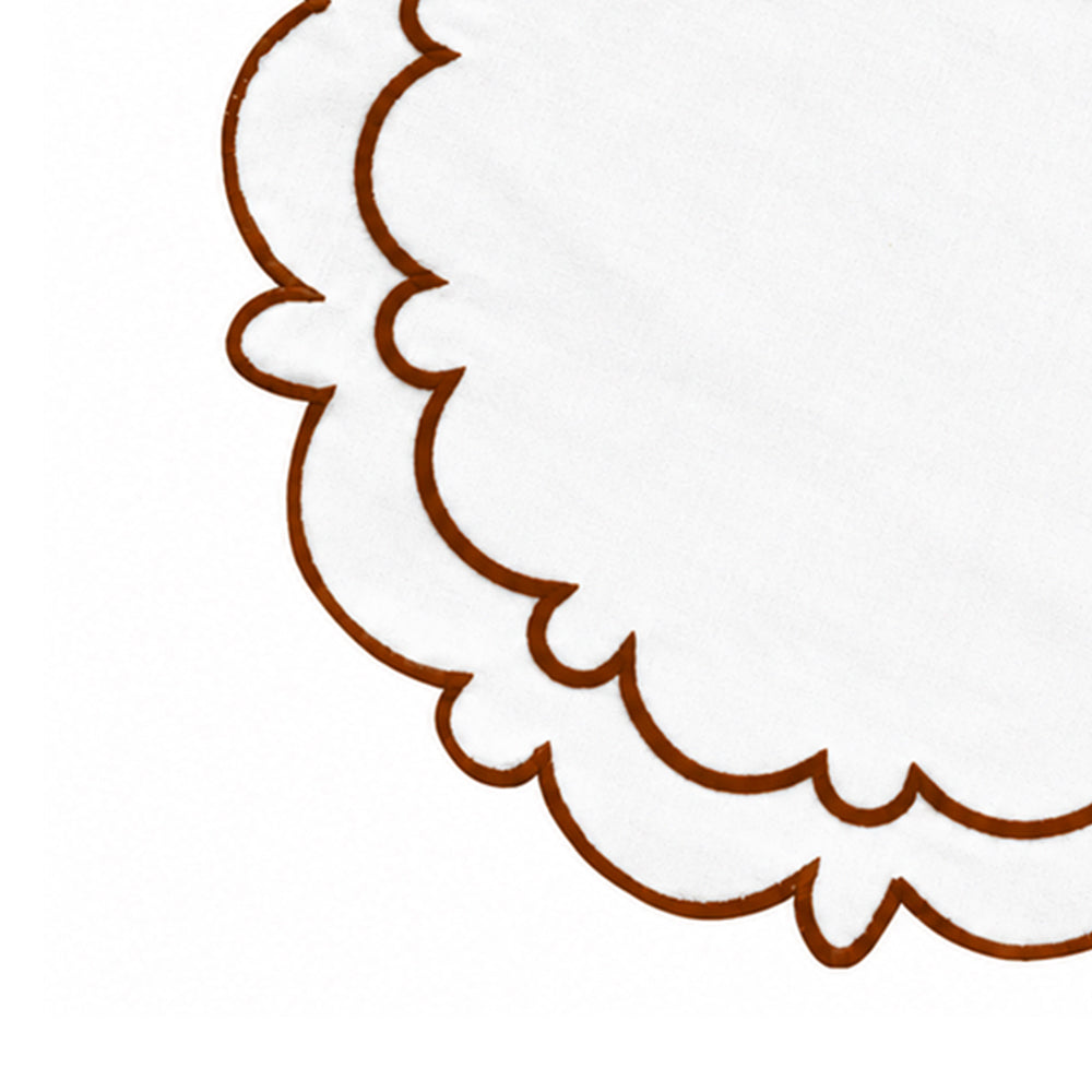 Brown-trimmed circular cotton table mat displayed with ceramic dinnerware and wooden table accents for a farmhouse wedding reception or holiday meal.