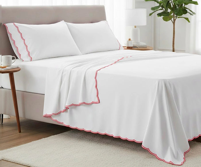Luxury red cotton sheet set with scalloped trim, deep pocket fitted sheet and matching pillowcases