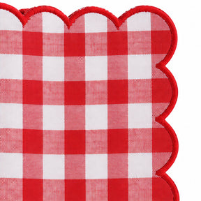 Close-up of red and white gingham cotton dinner napkin with matching red scalloped embroidered edge