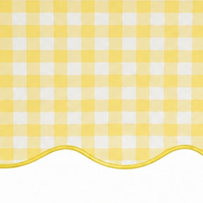 Close-up of yellow and white small checkered cotton tablecloth fabric highlighting the decorative scalloped edge border.