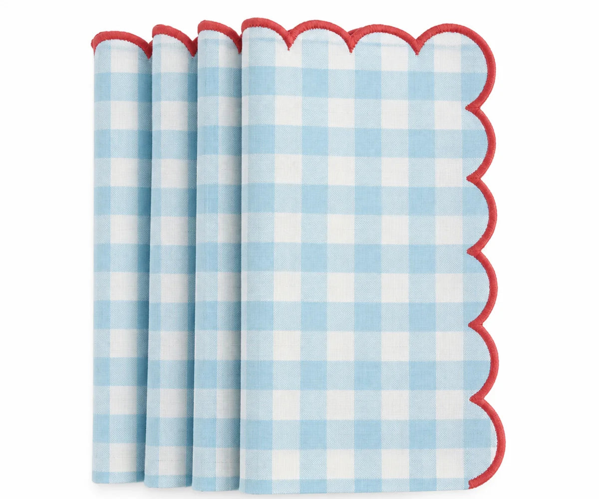 Set of light blue and white gingham cotton dinner napkins with red scalloped embroidered edges.