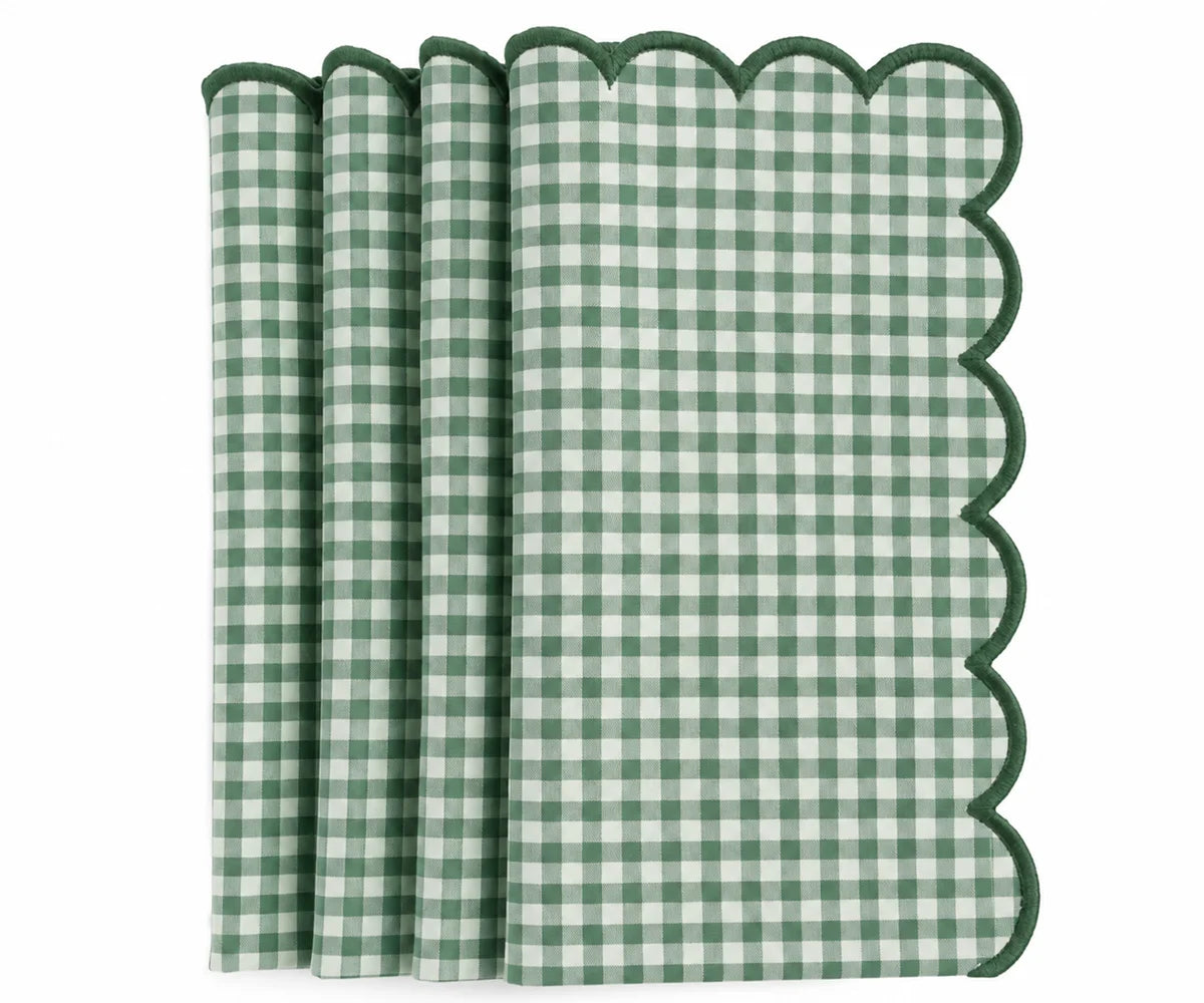 Set of green and white gingham cotton dinner napkins with scalloped embroidered edges.