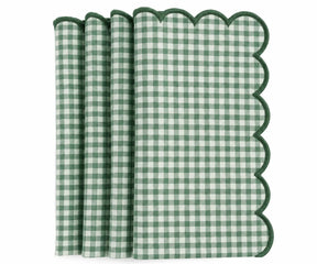 Set of green and white gingham cotton dinner napkins with scalloped embroidered edges.