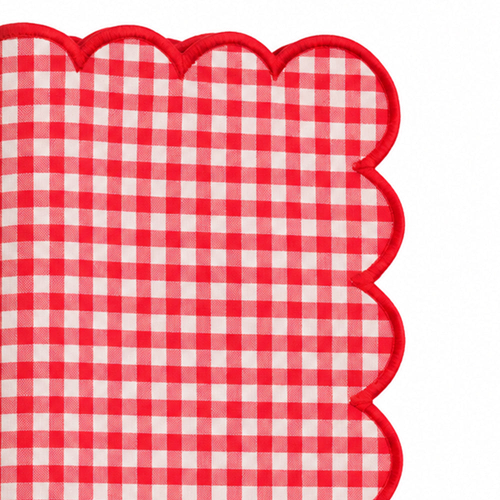 Close-up of red and white gingham cotton dinner napkin with matching red scalloped embroidered edge.
