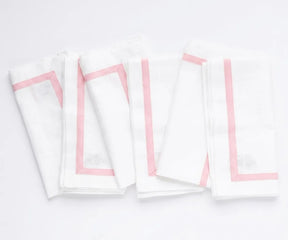 Reusable cotton dinner napkins featuring a classic border design for farmhouse, modern, and formal table settings.
