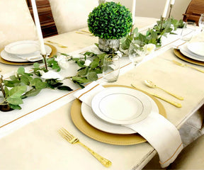 Elegant table setting with white dinner napkins and gold cutlery