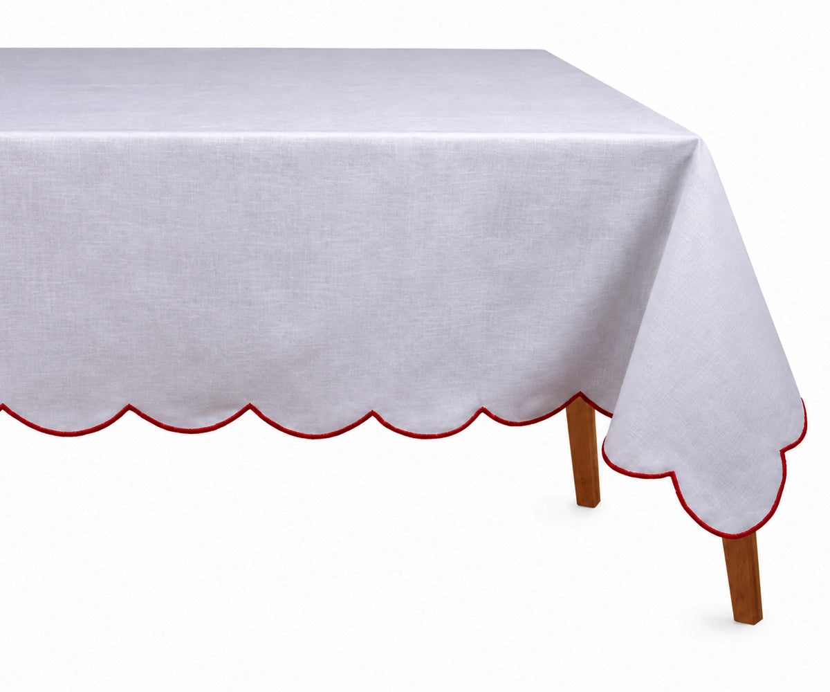 Elegant red cotton tablecloth with embroidered scalloped edges styled on a festive dining table.