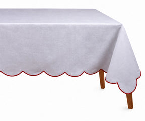 Elegant red cotton tablecloth with embroidered scalloped edges styled on a festive dining table.