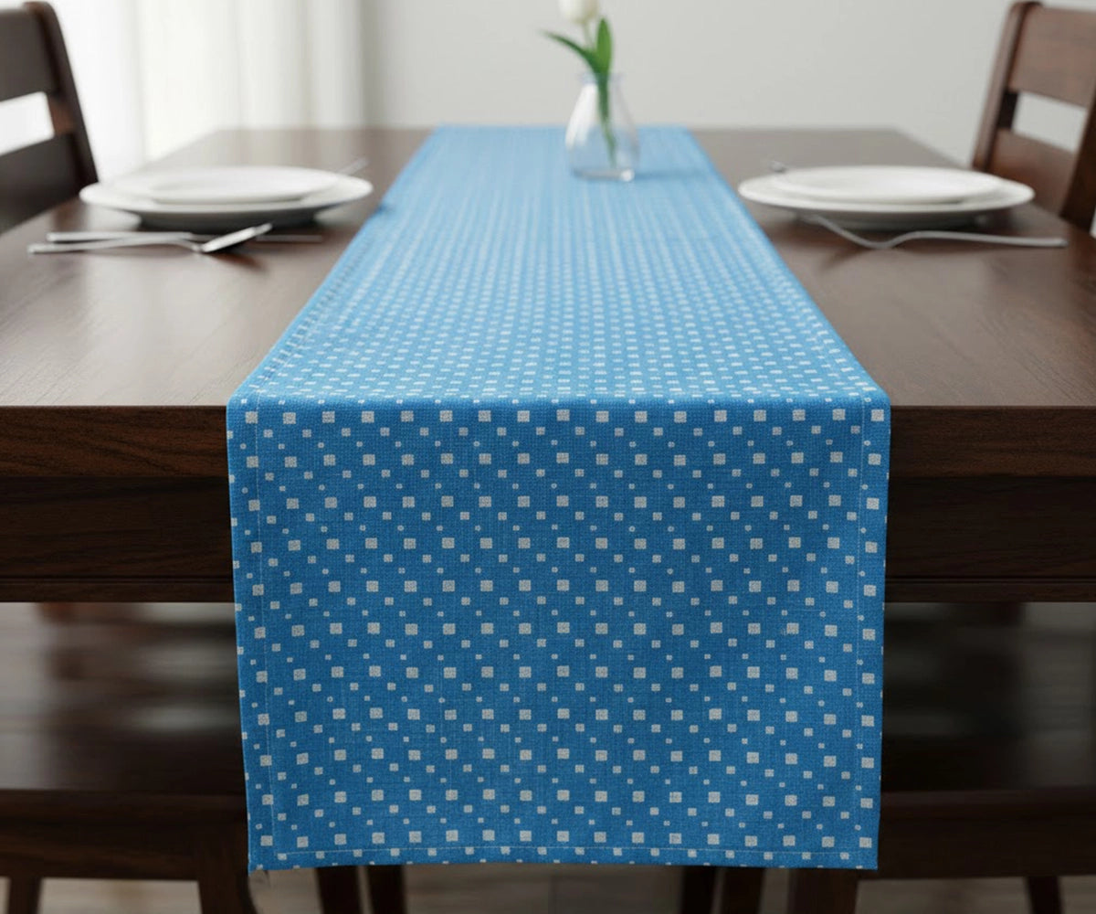 Blue cotton table runner with small white pattern on dining table