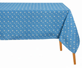Blue and white geometric cotton tablecloth on rectangular dining table with modern table setting