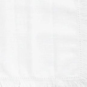 Reusable cotton dining napkins with fringe border design, suitable for home dining tables and party setups.