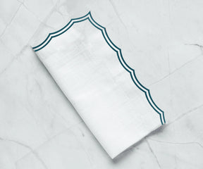 Close-up of embroidery on green cotton dinner napkin
