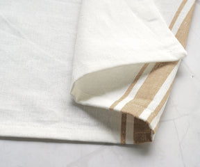 Tan and white striped bistro napkin displayed on a marble counter