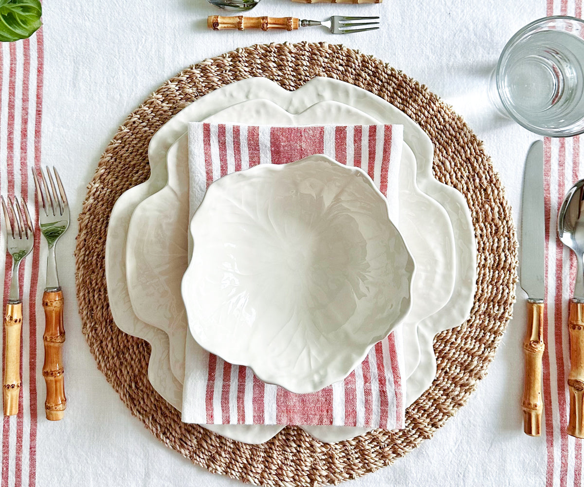 Linen dinner napkin with red and white stripes on a table setting