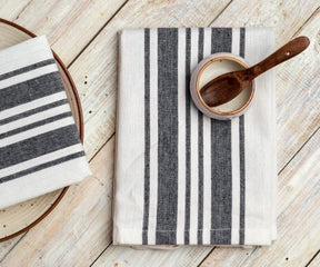 Wooden spoon resting on a striped restaurant napkin