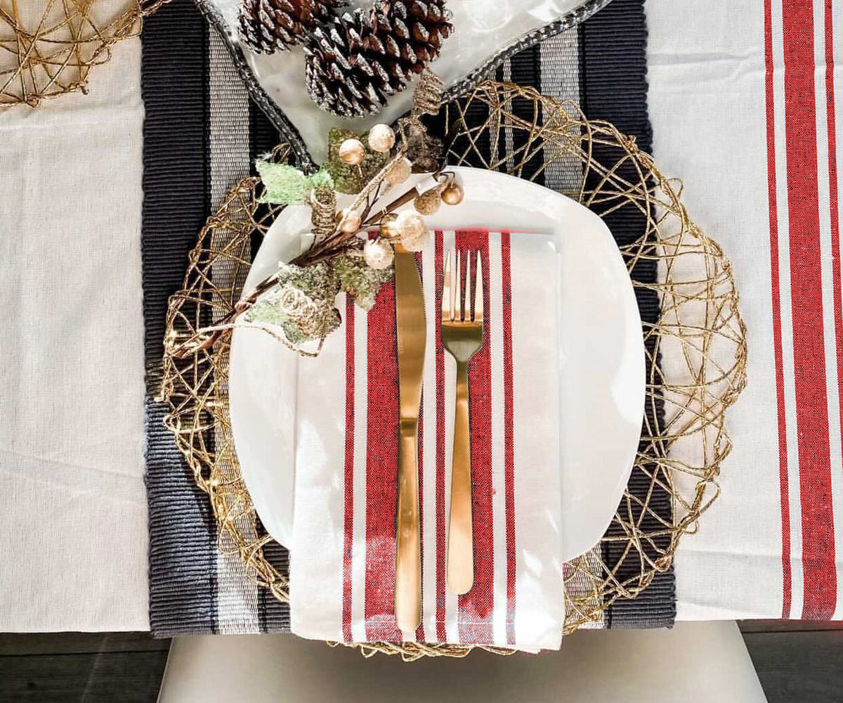 Table setting with red, white and blue striped restaurant napkin