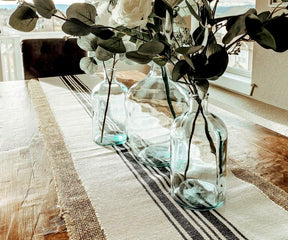 Add a touch of country elegance with a cotton table runner, designed for durability.