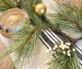 Create a cozy dining atmosphere with a striped runner, infusing rustic charm into your space.