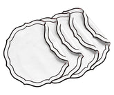 Top view of embroidered placemats on a dining surface