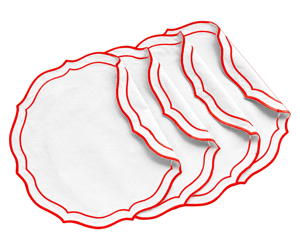 Red round scalloped cotton placemat on a dining table