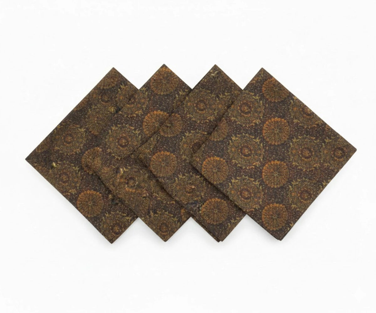 Dark beige linen dinner napkins with floral print arranged in layered display