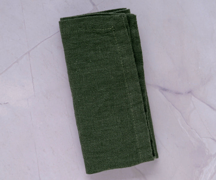 Dark green napkins, with their bold hue, create a captivating and stylish presence on your dining table.