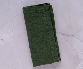 Dark green napkins, with their bold hue, create a captivating and stylish presence on your dining table.